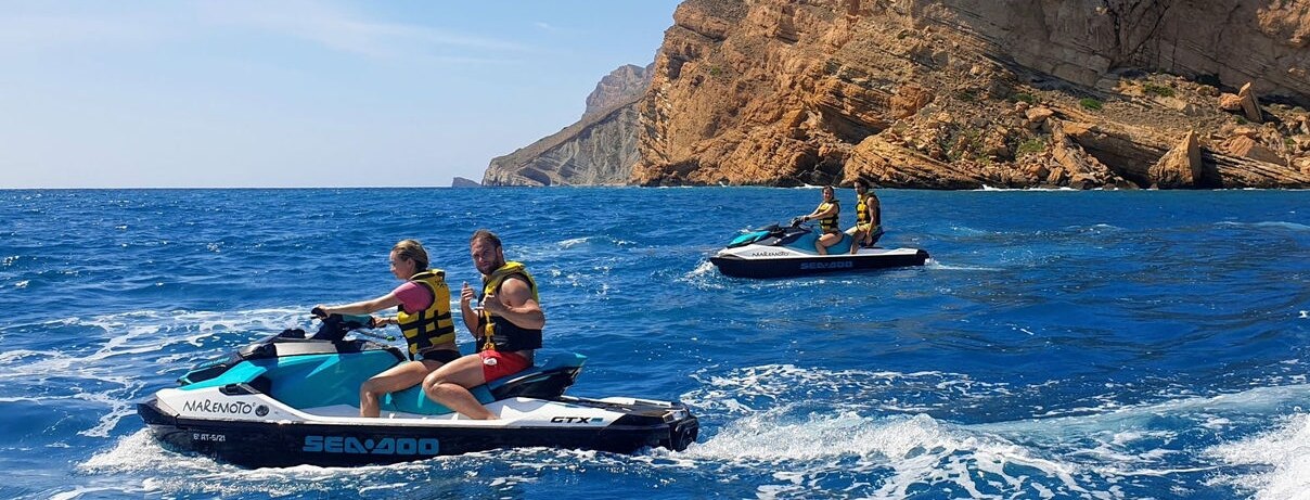 Two Sea-Doo personal watercrafts riding on the ocean