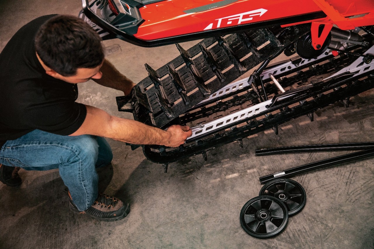 Ski-doo mechanic working on the track