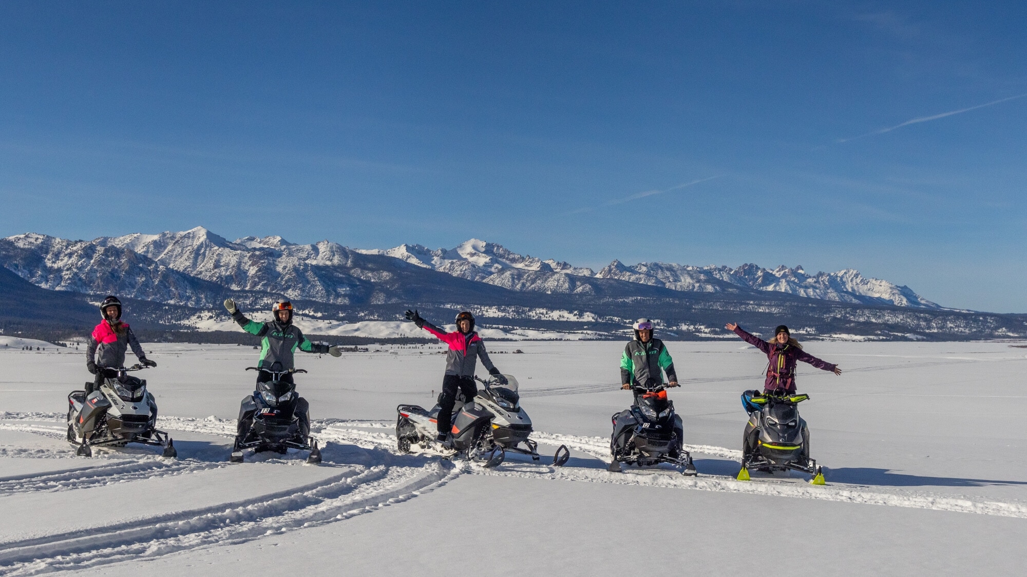 A group of people enjoying a snowmobile ride with Ski-Doo