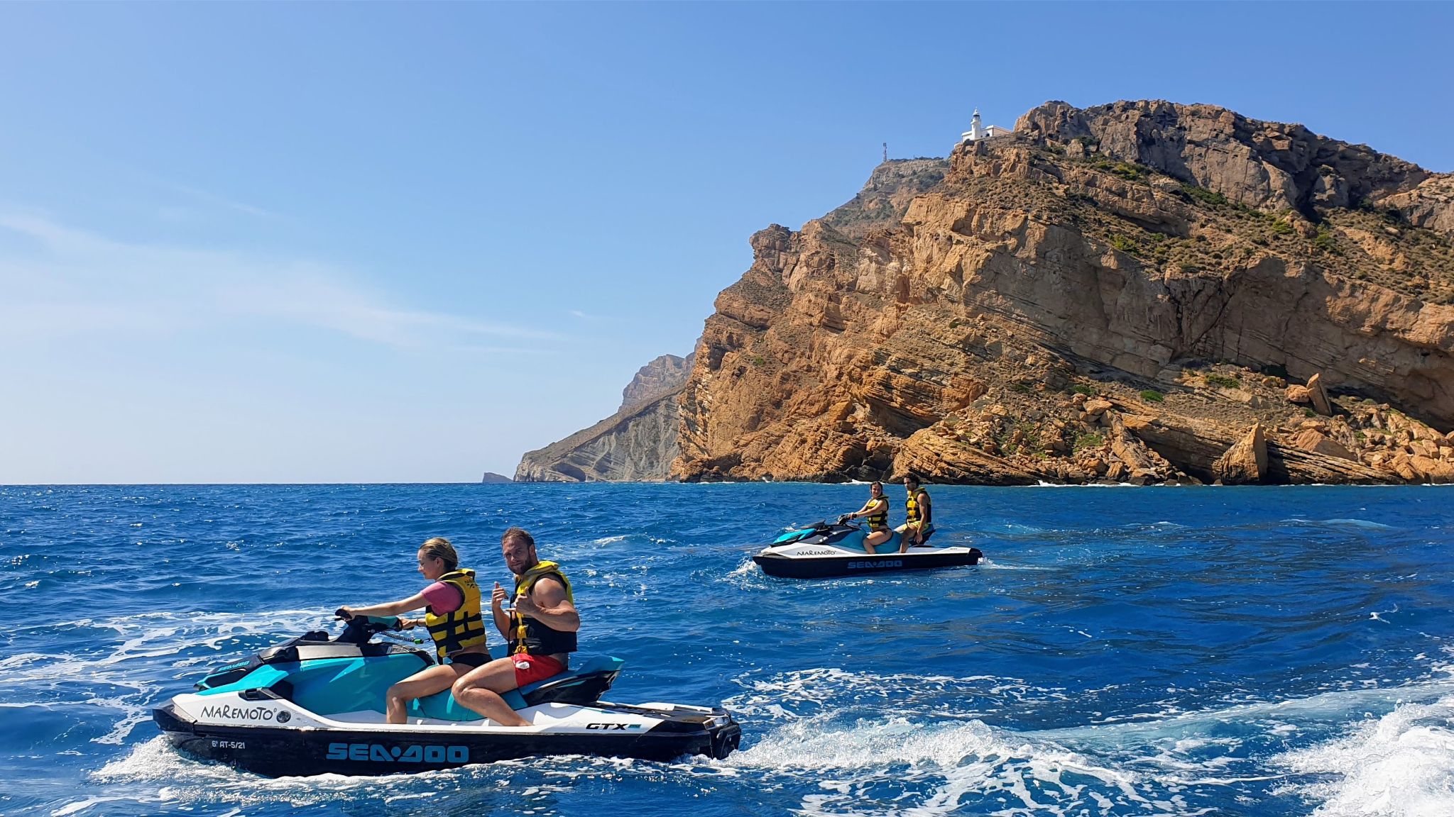 Two Sea-Doo personal watercrafts riding on the ocean