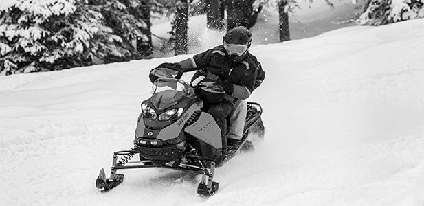 Snowmobile riding in a snowy forest